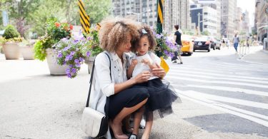Mare amb la seva filla al carrer d'un ciutat