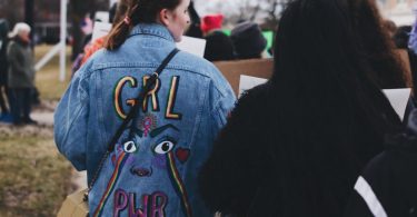 Noia amb una jacketa reivindicativa a una manifestació